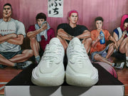 Front view of white Nike basketball sneakers showing the laces and toe.