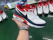 Nike Air Max BW-style sneaker shown in hand, with white, navy, red, and black color blocking.