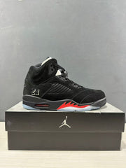 Side profile of a black Air Jordan 5 sneaker with red midsole accents and a number 23 detail.