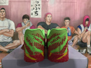 Rear view of the sneakers showing green heel panels, red patterned details, red outsoles, and TWELVE lettering.