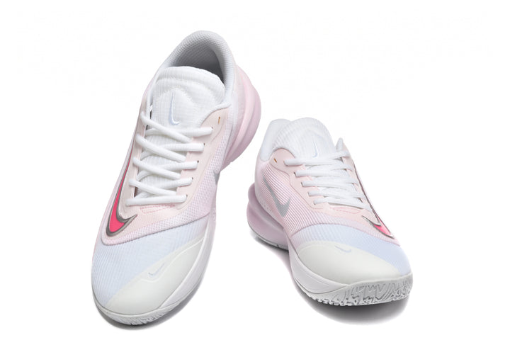 Pair of white and pale pink Nike Precision 7 basketball shoes shown from the front, with bright pink and silver Swooshes.
