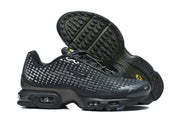 Black Nike Air Max Plus sneakers shown from the side and outsole.