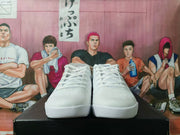Front view of a pair of white lace-up basketball sneakers with layered white soles.