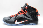 Side profile of a black and grey high-top basketball sneaker with orange laces, white Swoosh branding and a translucent sole.