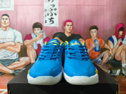 Front view of blue Jordan basketball shoes with yellow details