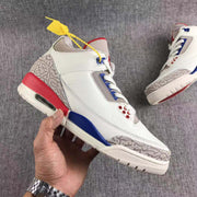 Single sneaker shown in side profile with a white upper, patterned grey toe and heel panels, blue accents, and a red heel section.