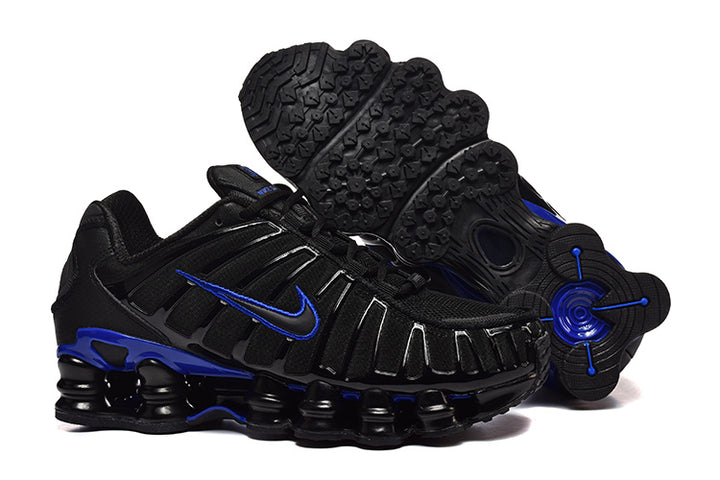 Black Nike Shox TL sneakers with blue accents, shown from the side with the patterned outsole visible.