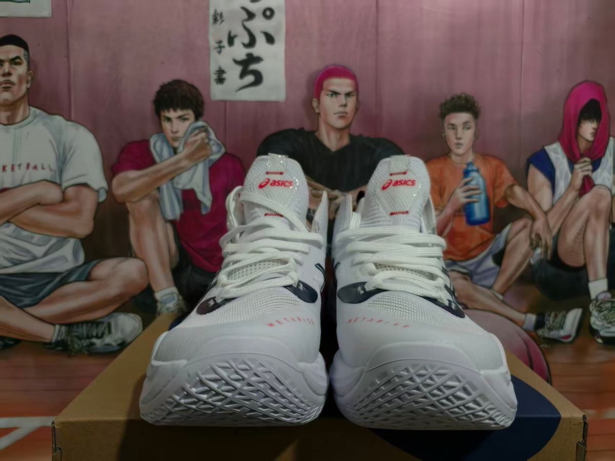 Front view of white ASICS METARISE volleyball shoes with navy and red accents