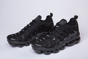 Pair of black Nike-style sneakers shown from a front three-quarter angle.