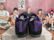 Rear view showing the purple heel panels, black heel sections, and speckled outsole.