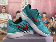 Angled view of paired teal sneakers showing red Nike swooshes, black side detailing, white midsoles, and textured outsoles.