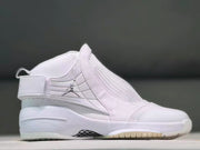 Side view of a white Jordan 19 high-top sneaker with an ankle strap and patterned outsole.