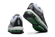 Rear and outsole views of the white, black, and green Nike sneakers.