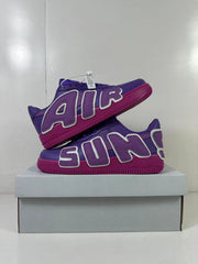 Stacked product view showing the AIR lettering on both sides of the purple sneakers.