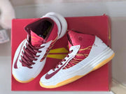 Pair of red, white, and yellow high-top basketball shoes shown from above