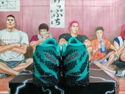 Rear view showing teal heel panels, red TWELVE lettering, and textured black outsoles.