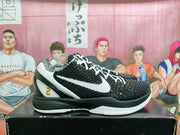 Side view of black and white Nike basketball sneakers showing the textured upper, white side branding, white laces, and black-and-white sole.
