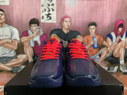 Front view of the basketball sneakers showing red laces, perforated toe areas, and basketball-style logos on the tongues.