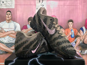 Angled side view showing the pink Swoosh detail and patterned brown upper