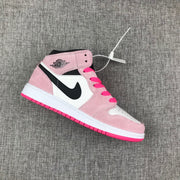 Single pink, white and black Jordan Air Jordan 1 Mid sneaker shown from the side.