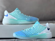 Side view of the blue and aqua sneaker with a translucent patterned upper and textured outsole.