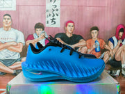 Side view of a vivid blue basketball sneaker showing its textured side panel, black laces, and Nike Swoosh.