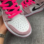 Close-up of the perforated white toe box and bright pink laces.