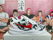 Side view of a white, black, and gray basketball-style sneaker with a red Nike swoosh and patterned upper.