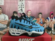 Blue and white Nike sneaker shown from the side on a red Nike shoebox.