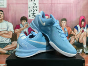 Angled view of blue Nike shoes showing the side Swoosh, heel details, and patterned outsole.