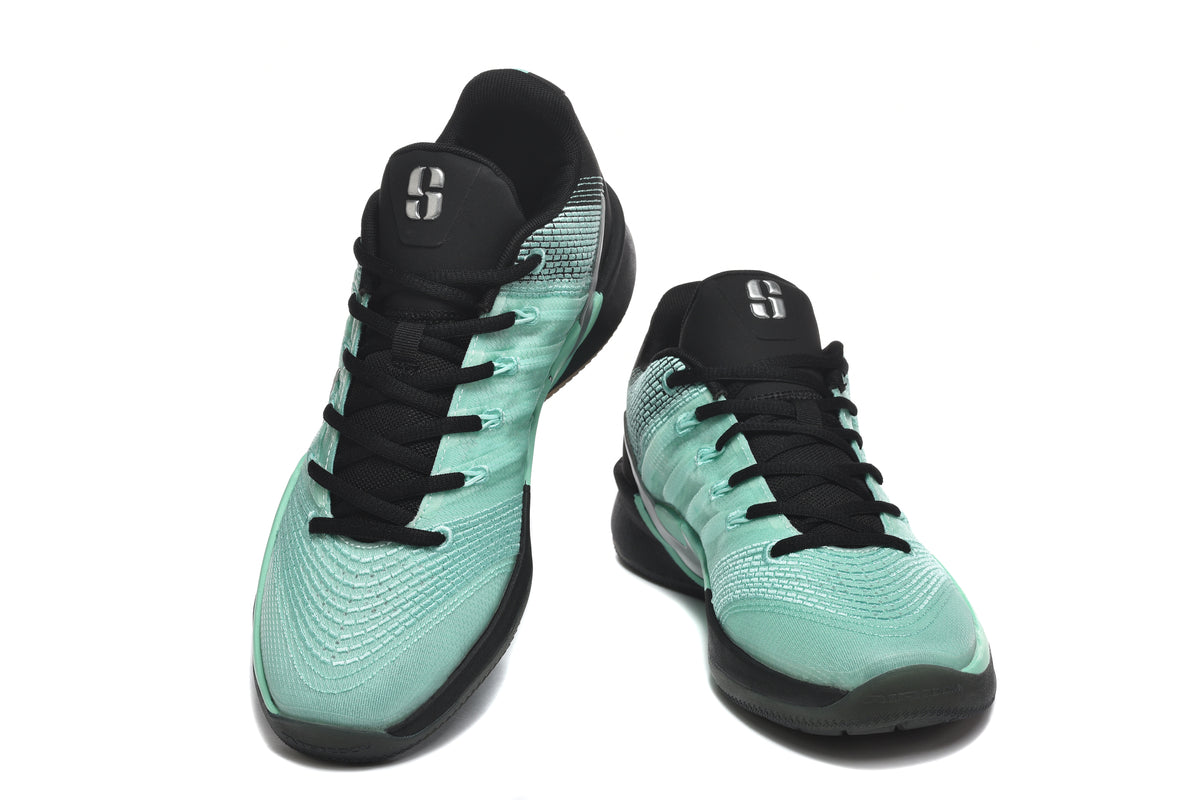 Pair of green-and-black low-top basketball shoes shown from the front