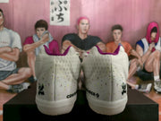 Rear view showing the speckled heel panels and Converse branding on the white sneakers.