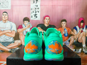 Rear view of green Nike basketball shoes with colorful heel graphics.