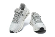 Pair of light gray On running shoes shown from front and overhead angles.
