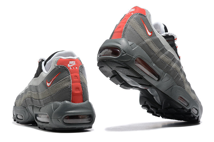 Nike Air Max 95 TT sneakers shown from the rear and underside, with grey panels and red accents