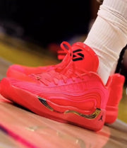 Angled view of a red Jordan 921-5 sneaker showing the lace-up upper, tongue logo, sculpted side panels, and heel branding.