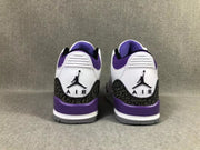 Rear view of the white and purple Jordan sneakers showing the embroidered heel logos and dark patterned heel overlays.