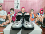 Front view showing the patterned upper, black laces, red tongue logos, and black toe outsole.