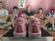 Rear view of pink Nike sneakers showing red heel detailing, floral graphics, and white midsoles.