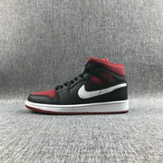 Full lateral profile of a black and red mid-top sneaker with a white Swoosh and white midsole.