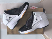Angled top view of the sneakers showing the ankle straps, black woven-look panels, and white uppers.