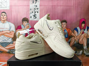 Angled view of white perforated sneakers with thick midsoles
