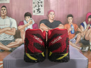 Rear view of red, black, and yellow basketball-style sneakers showing “TWELVE” heel lettering.