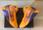 Overhead view of the pair with gold-yellow uppers and purple accents