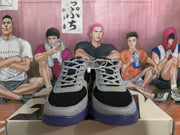 Front view showing the gray laces, black toe panels, gray overlays, and purple outsole edges.