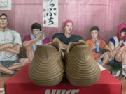 Rear view of khaki Nike sneakers showing the sculpted heel and layered ridged sole on a red Nike shoebox.