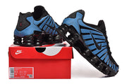 Blue and black Nike Shox-style sneakers displayed on a shoe box; the box label shows a sample size.