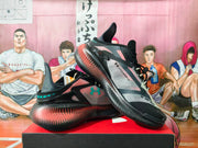 Angled view of the black and pink basketball shoes with turquoise accents