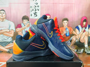 Angled view of navy Nike Kobe basketball shoes with yellow side detailing and orange-red laces