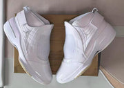 Top-down view of a pair of white Jordan 19 sneakers with ankle straps.